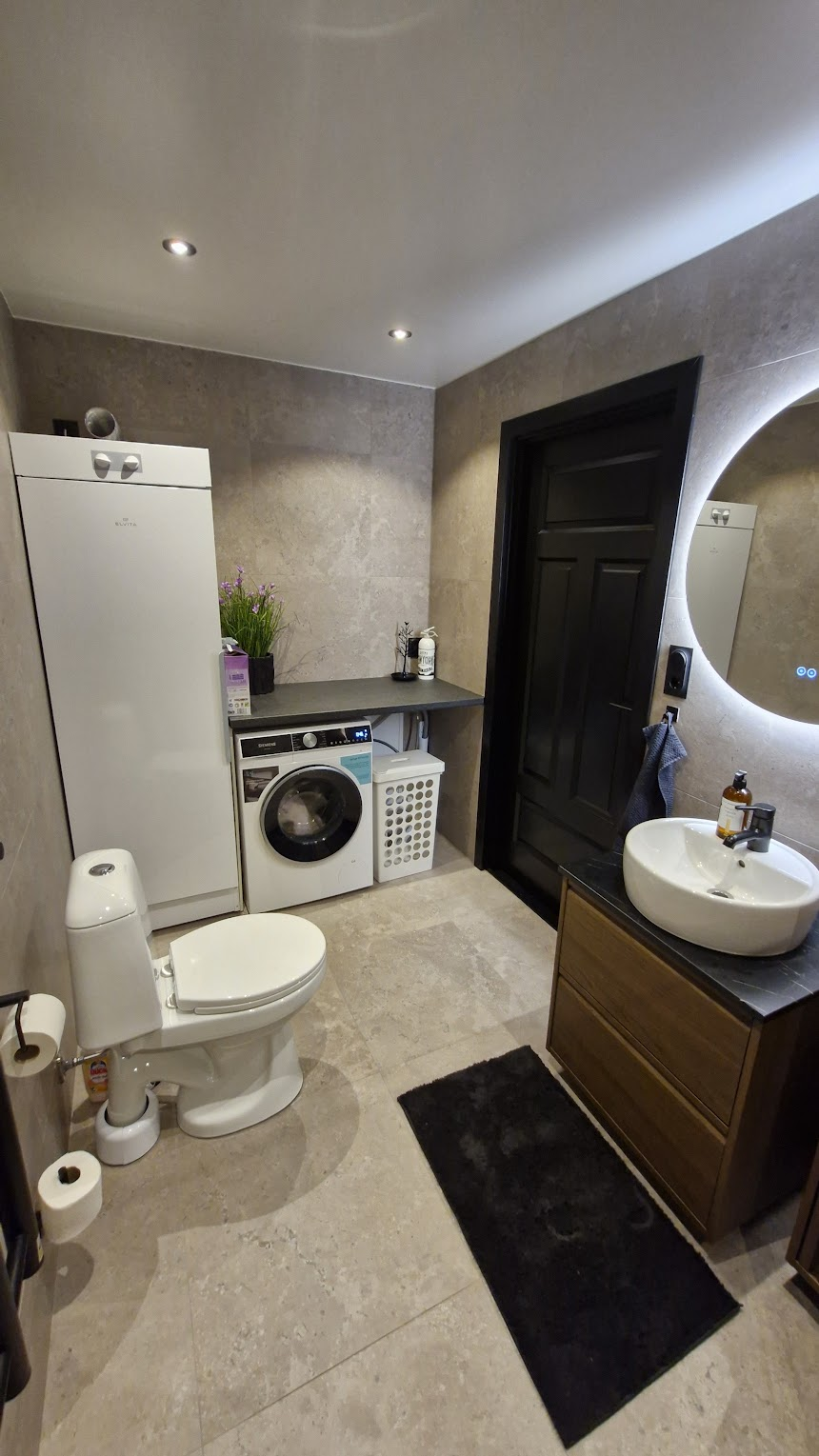 Bathroom with washing machine and drying cabinet